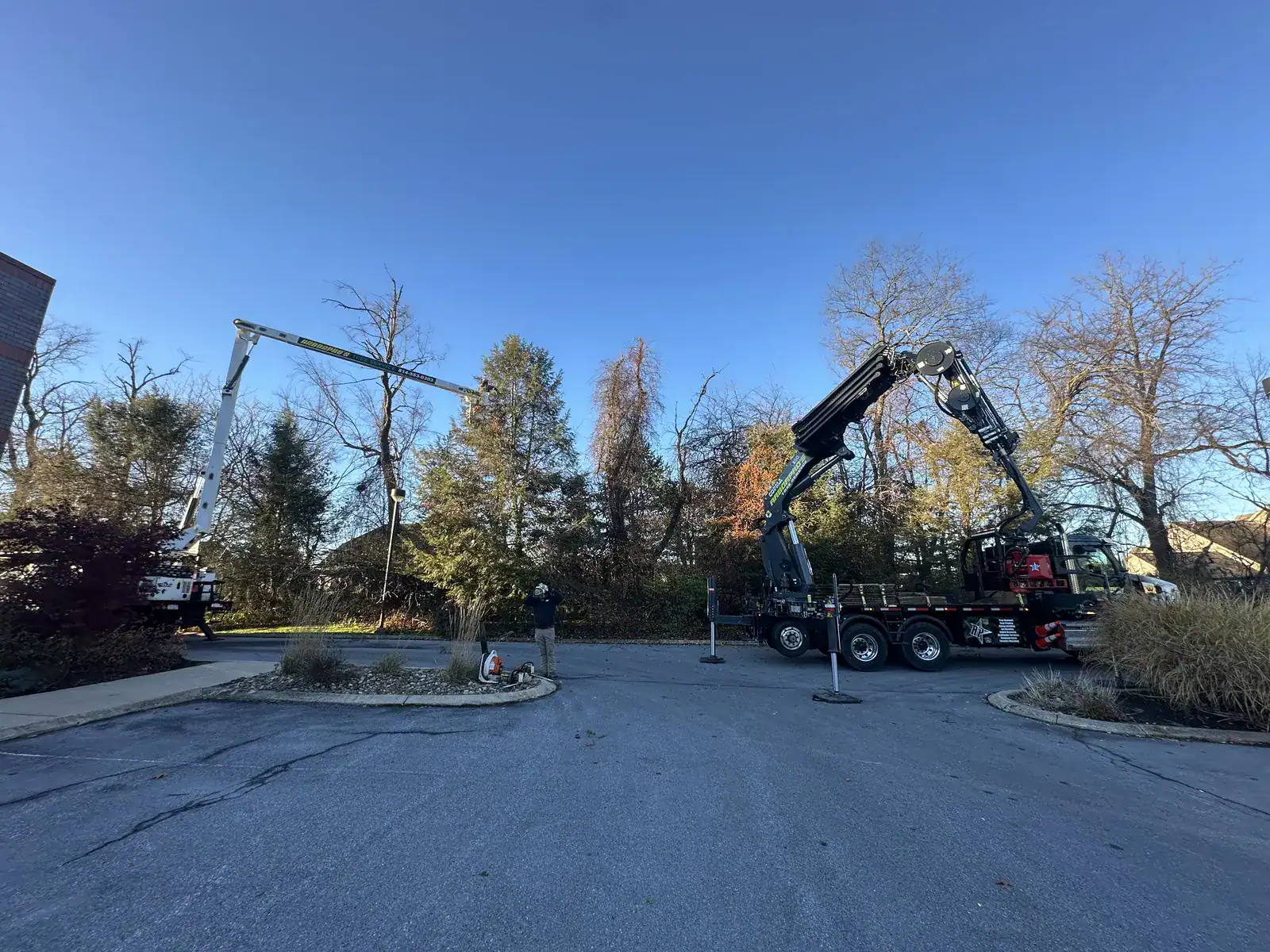 Arbor Pro's knuckle boom crane and bucket truck working a tree removal in Central PA